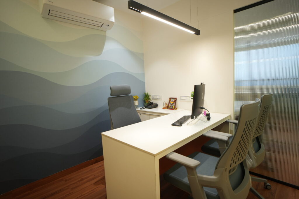 4-seater meeting table with glass partitions for small corporate offices in Ahmedabad.