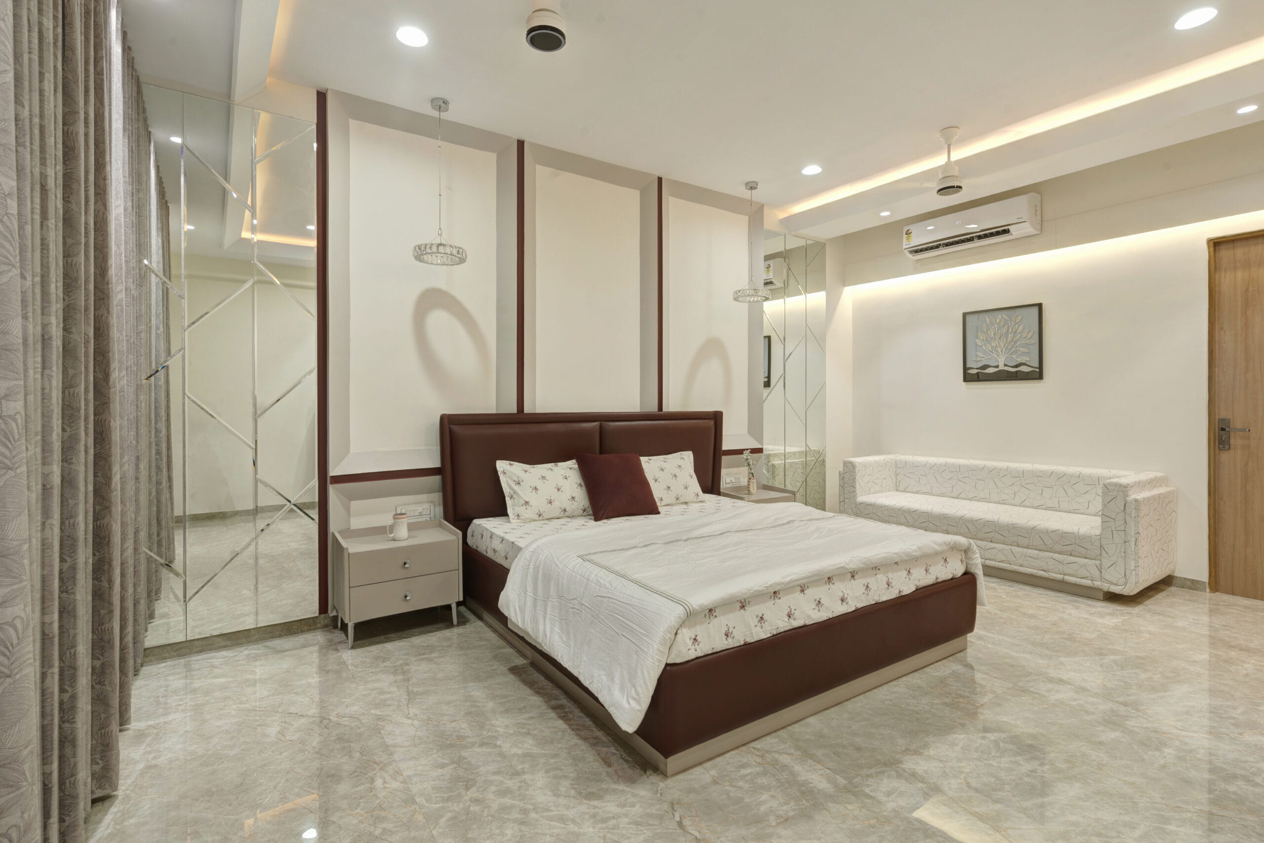 Elegant master bedroom interior with customized full-height wardrobe and king-size bed in Ahmedabad.